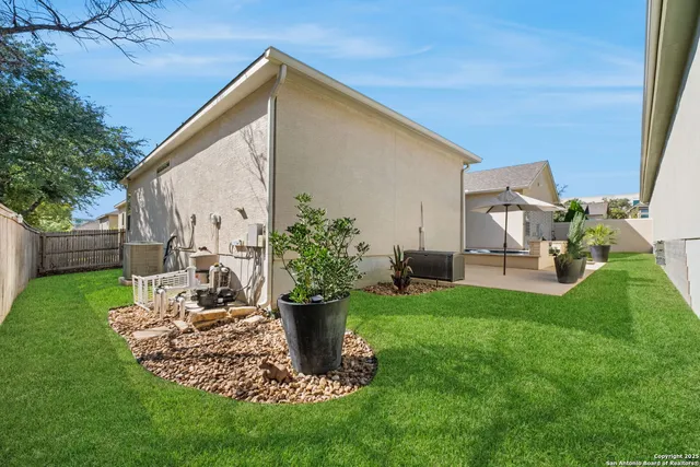 a view of a backyard with plants and a patio