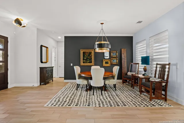 a dining room with furniture a rug a rug and a chandelier