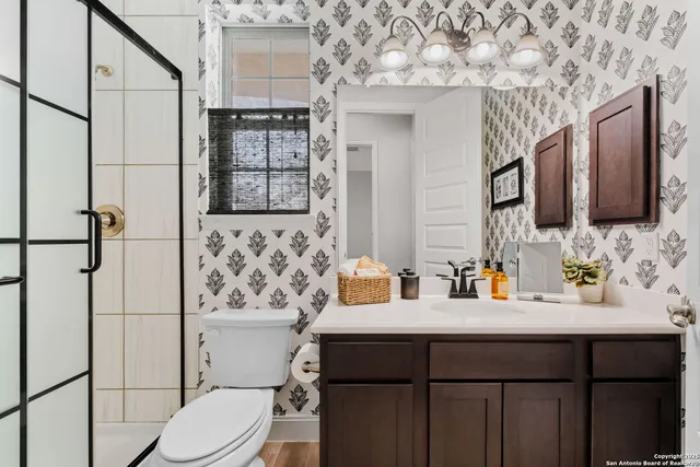 a bathroom with a sink toilet and shower