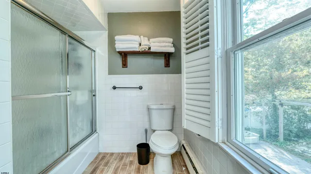 a bathroom with a toilet and a shower
