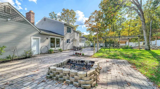 a view of a house with backyard and sitting area