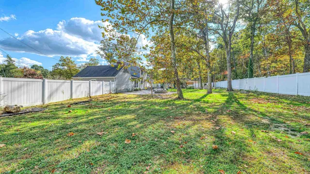 a view of yard with swimming pool and seating area