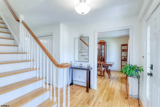 a view of entryway with wooden floor and stairs