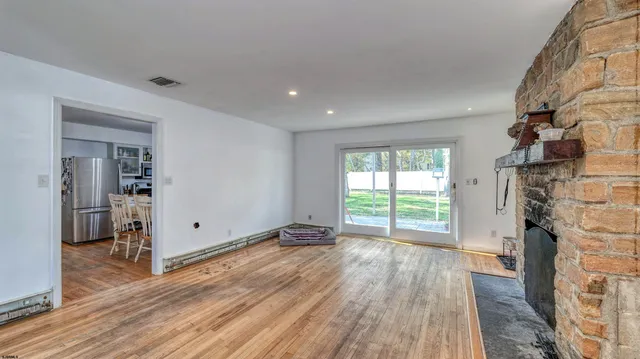 wooden floor in an empty room with a fireplace
