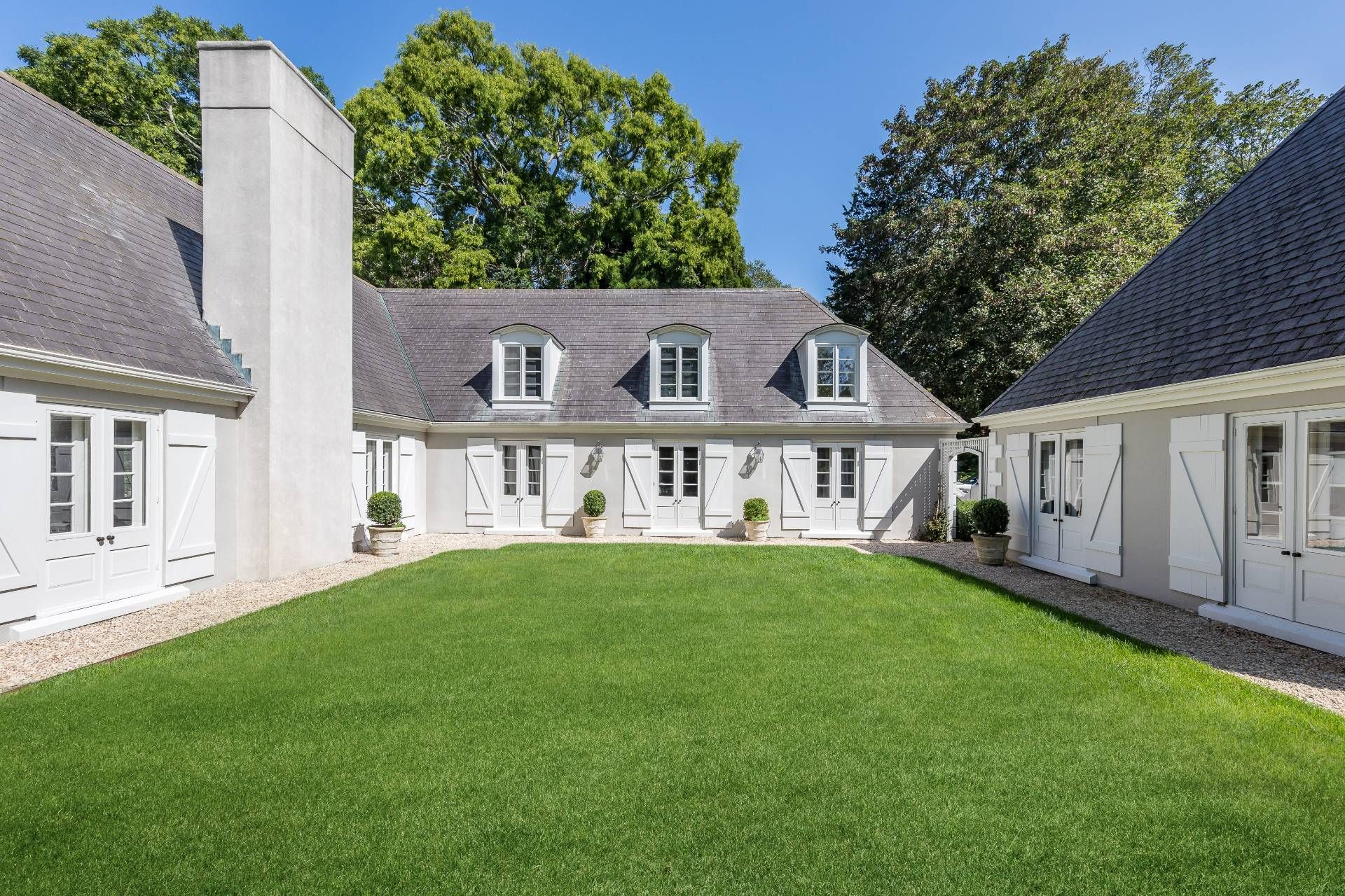 30 Darby Lane East Hampton, NY 11937 - Photo 1 of 34 a front view of a house with a garden