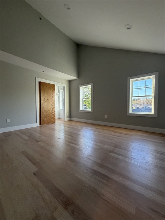 944 East Street, Unit 3 Walpole, MA 02081 - Photo 17 of 23 an empty room with wooden floor and windows