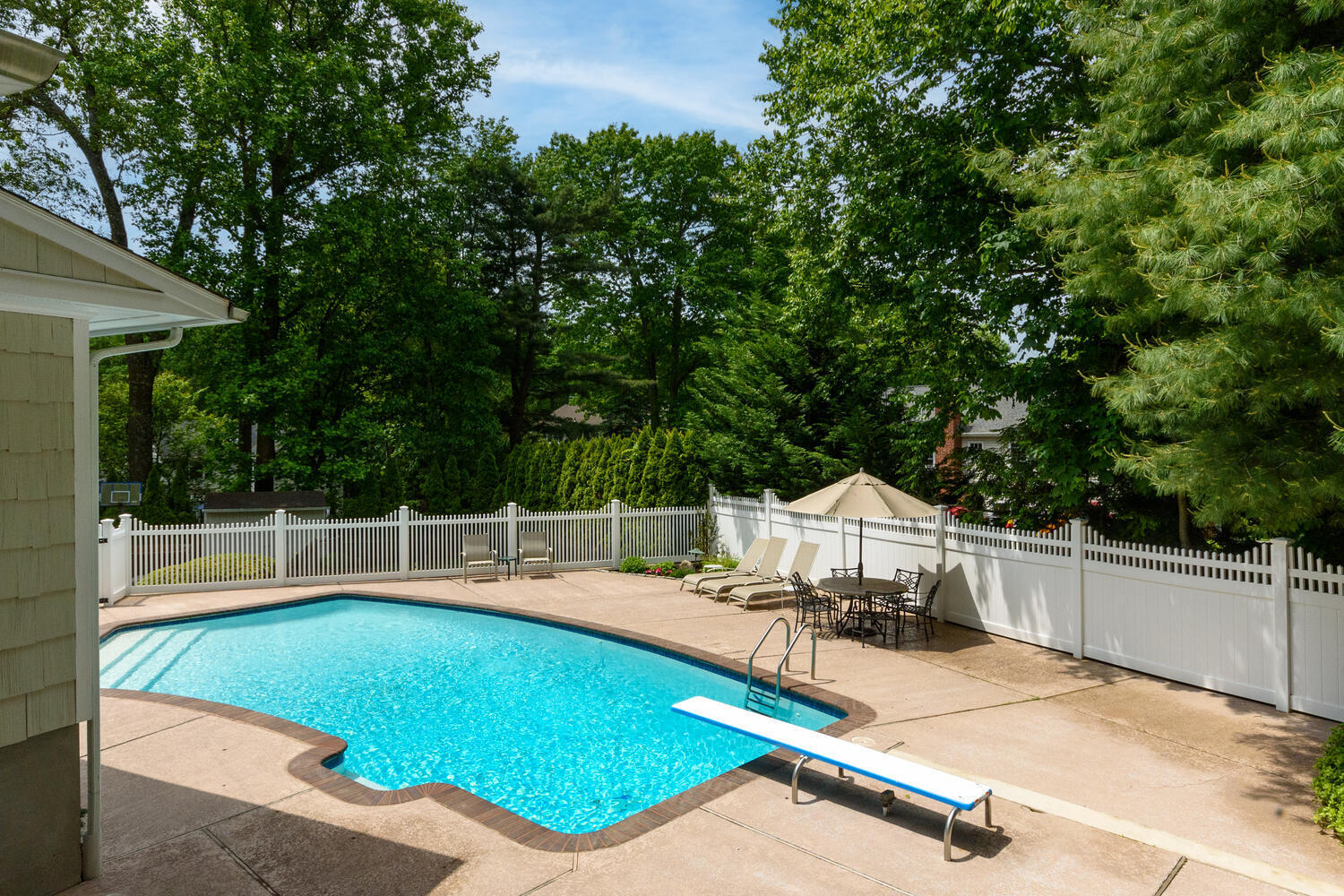 32 Barringer Road Darien, CT 06820 - Photo 20 of 28 a view of a chairs and table on the wooden deck