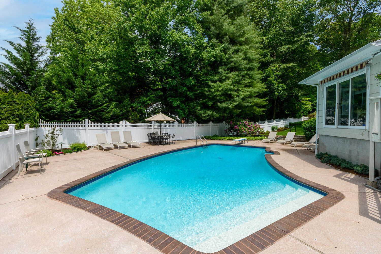 32 Barringer Road Darien, CT 06820 - Photo 24 of 28 a view of a swimming pool with a lounge chairs