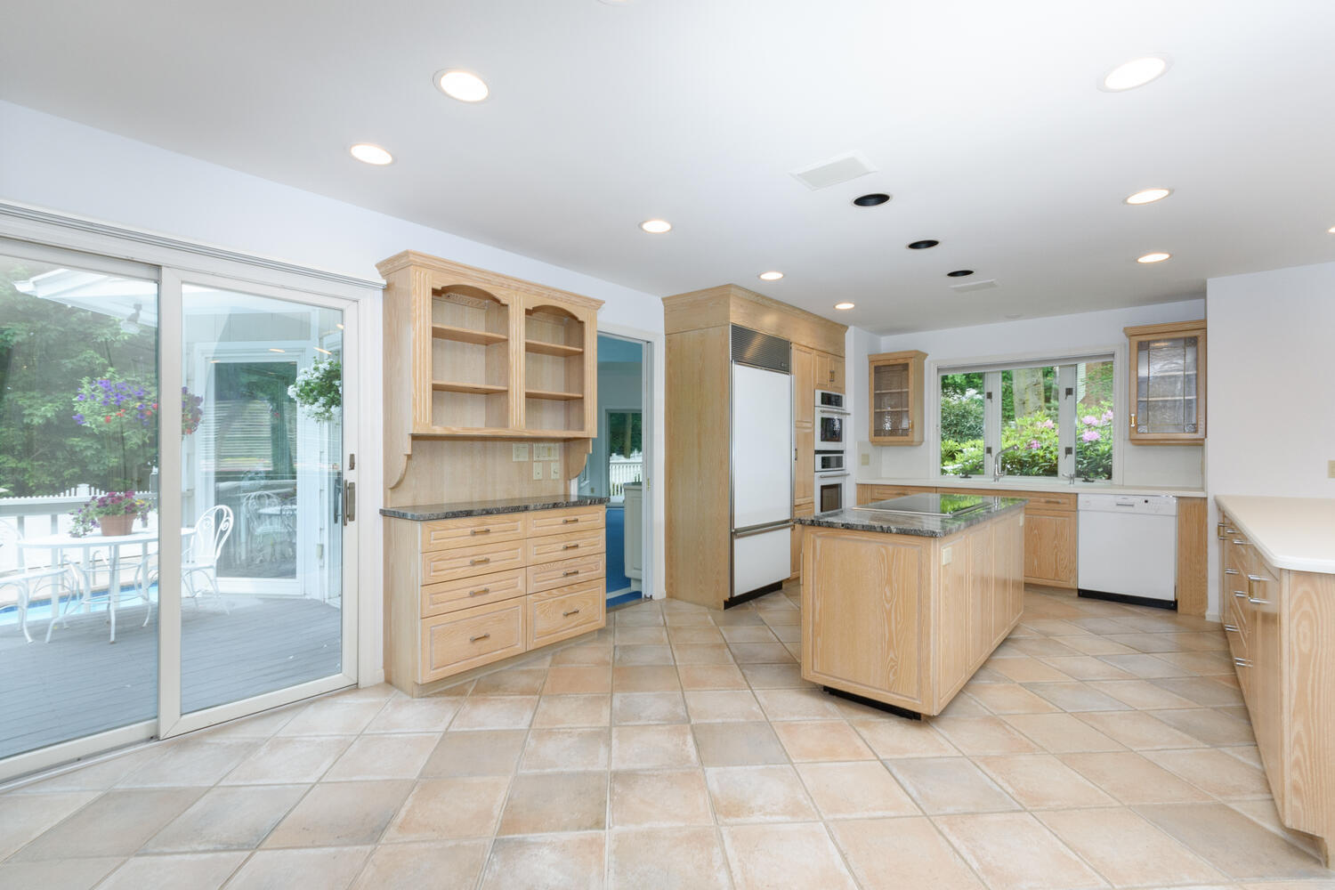 32 Barringer Road Darien, CT 06820 - Photo 9 of 28 a kitchen with a refrigerator and white cabinets