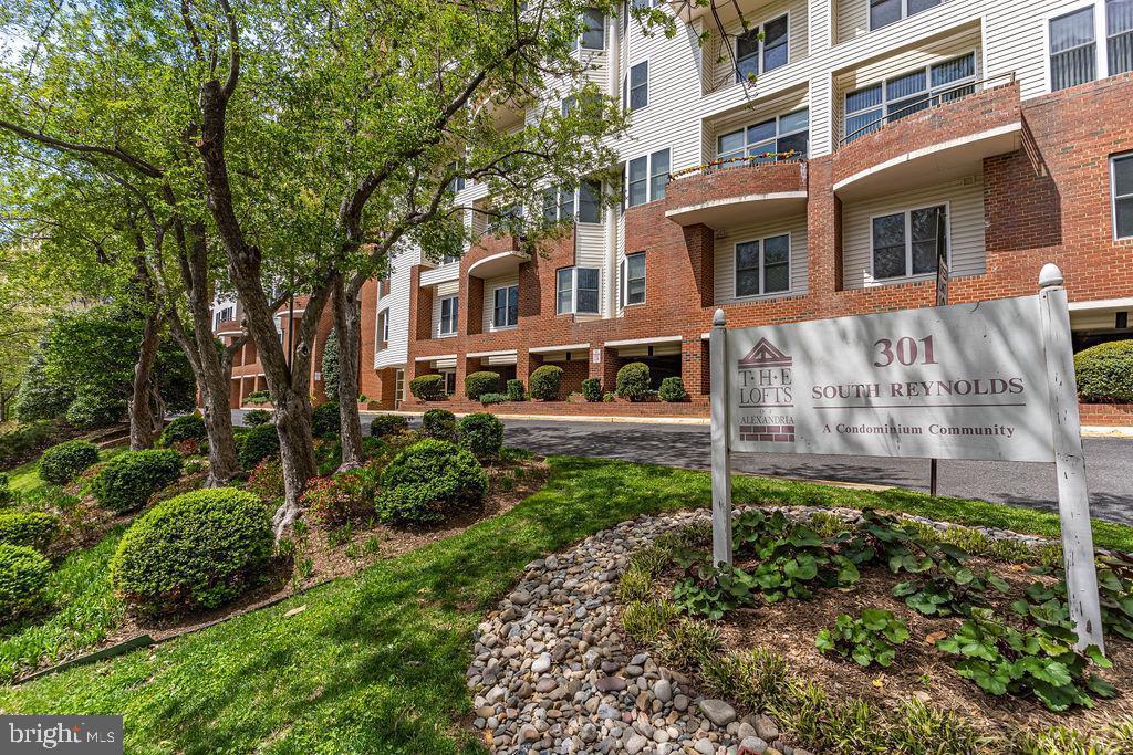 301 South Reynolds Street, Unit 607 Alexandria, VA 22304 - Photo 2 of 16 a view of a brick house with a yard and plants
