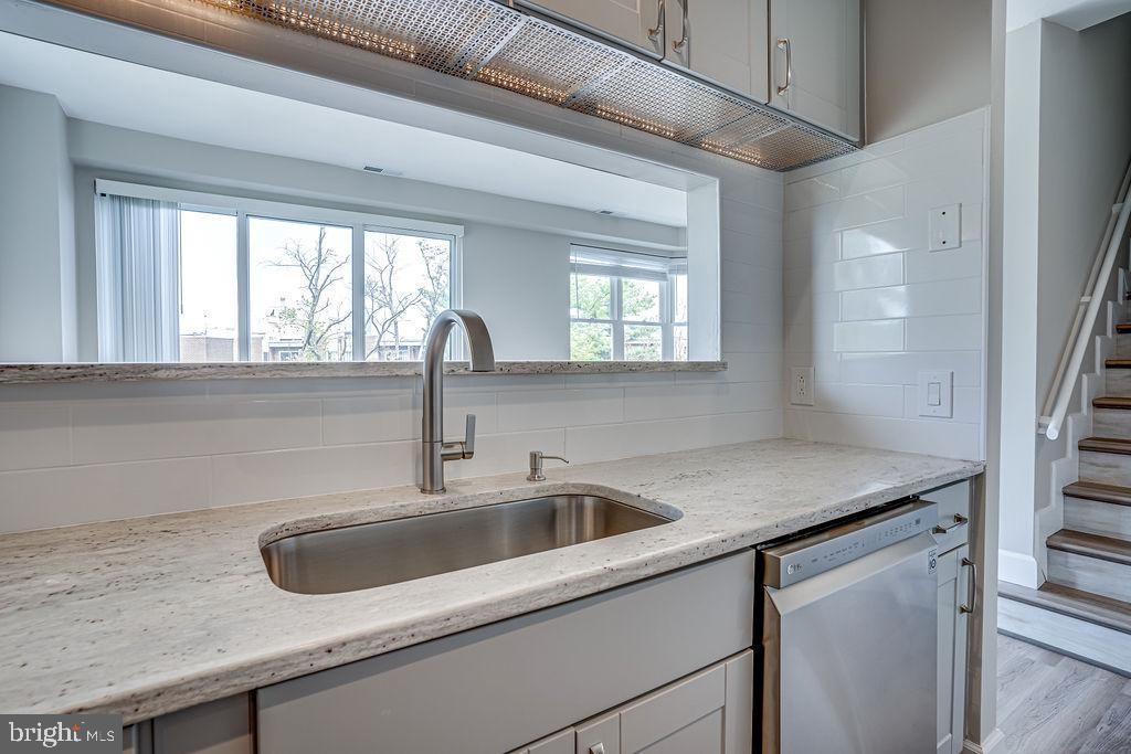 301 South Reynolds Street, Unit 607 Alexandria, VA 22304 - Photo 6 of 16 a kitchen with a sink and wooden floor