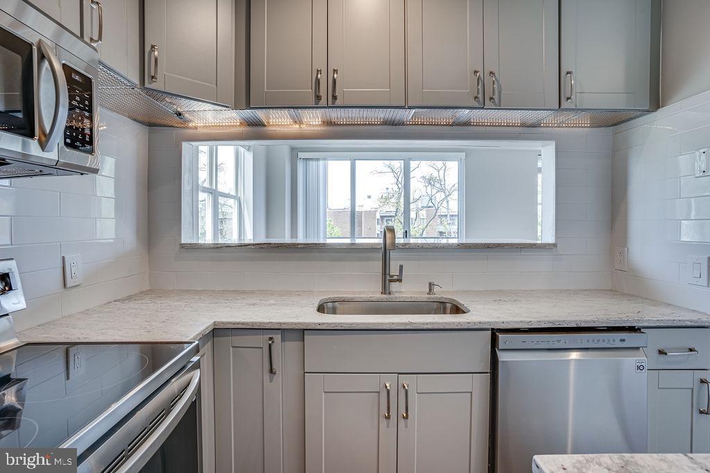 301 South Reynolds Street, Unit 607 Alexandria, VA 22304 - Photo 7 of 16 a kitchen with stainless steel appliances granite countertop a sink and a stove
