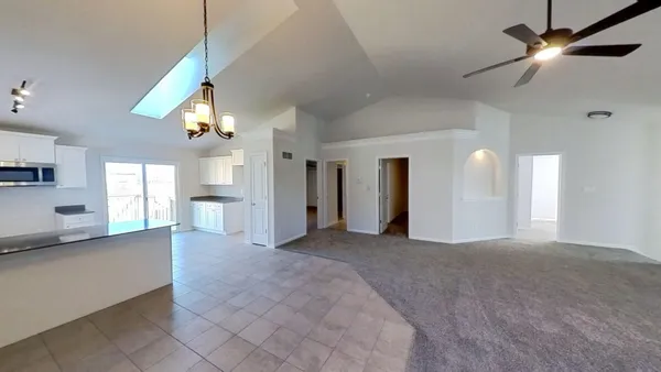 a view of an empty room with window and cabinet