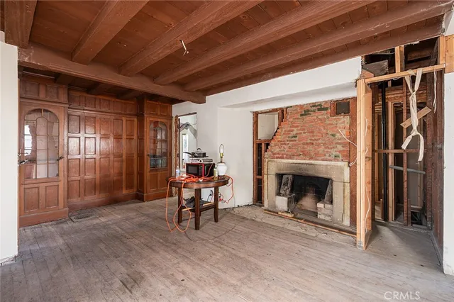 a living room with furniture a fireplace and a table