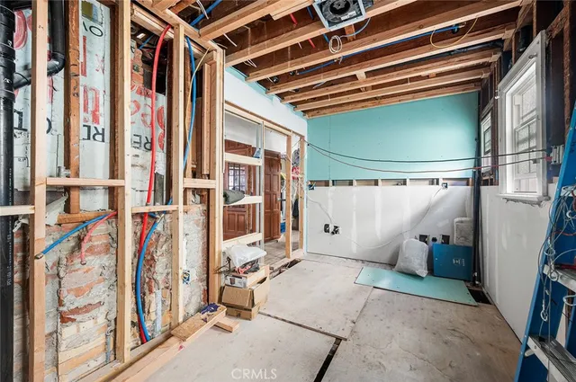a view of a hallway with wooden floor and entryway