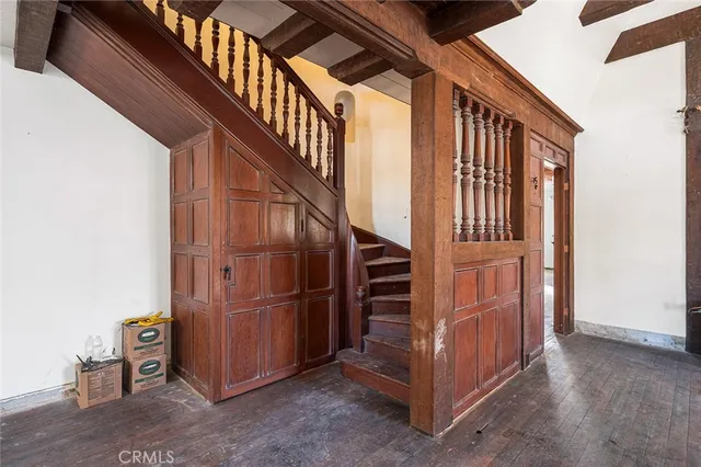 a view of staircase with railing and white walls