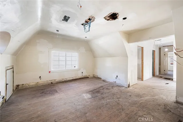 an empty room with windows and dryer