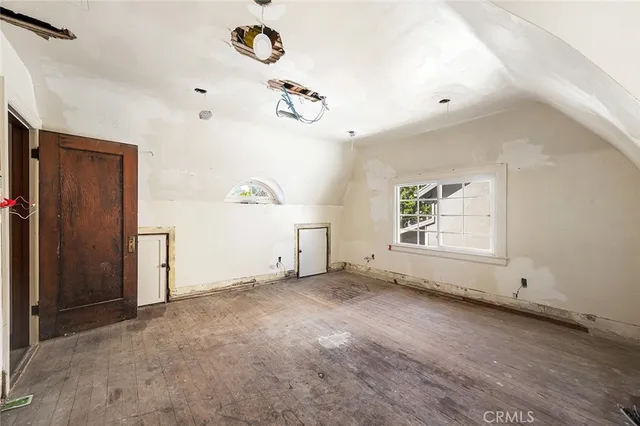a view of a livingroom with wooden floor and staircase