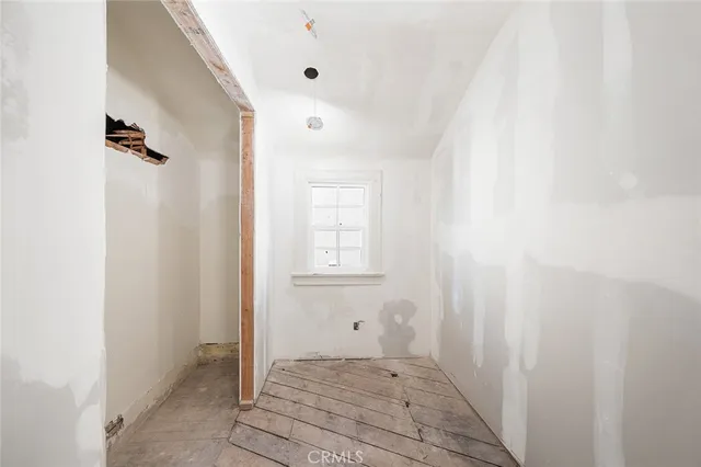 a view of walk in closet with clothes
