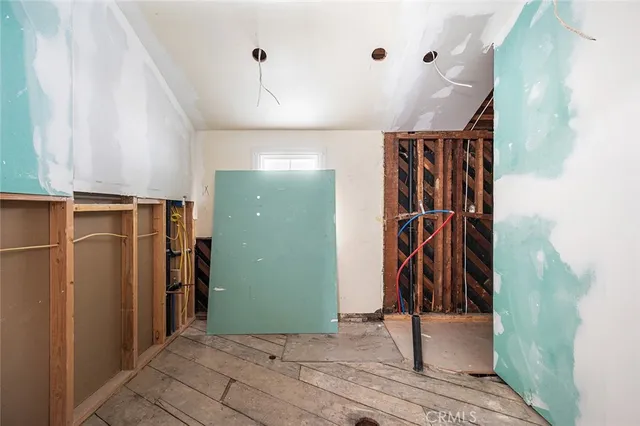 a view of a room with rack on the wall and a window