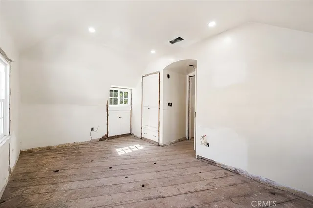 a view of a hallway with wooden floor and dining room