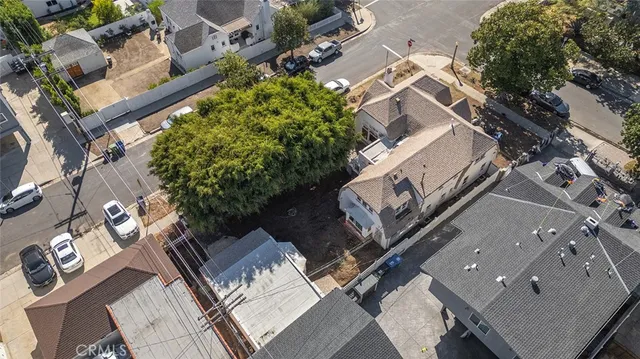 an aerial view of multiple houses with yard