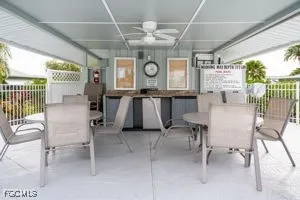 a view of swimming pool with outdoor seating and palm tree