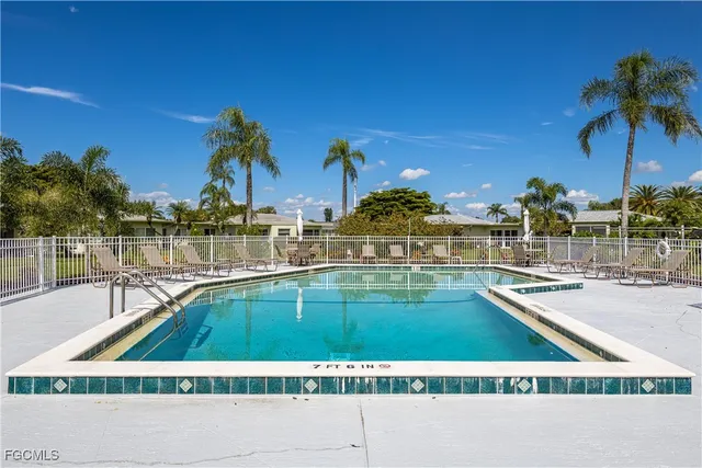 an aerial view of residential houses with outdoor space and swimming pool