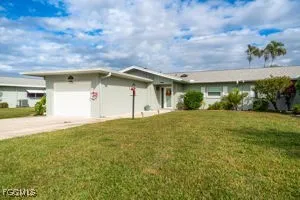 a yellow house with a garden in front of it