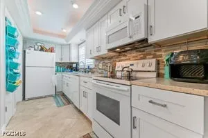 a kitchen with stainless steel appliances granite countertop a refrigerator sink and cabinets