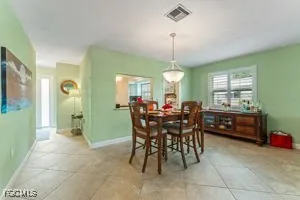 a living room with couches and large windows