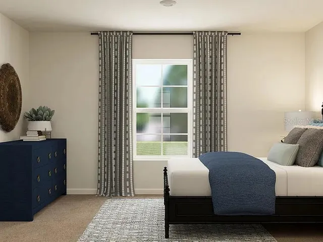 a bedroom with a bed and window