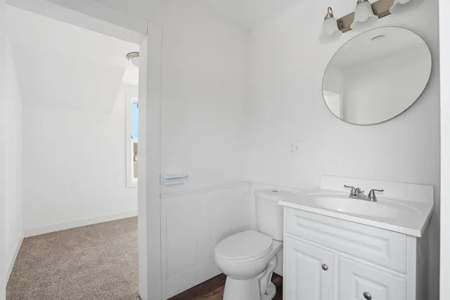 a bathroom with a sink mirror and toilet