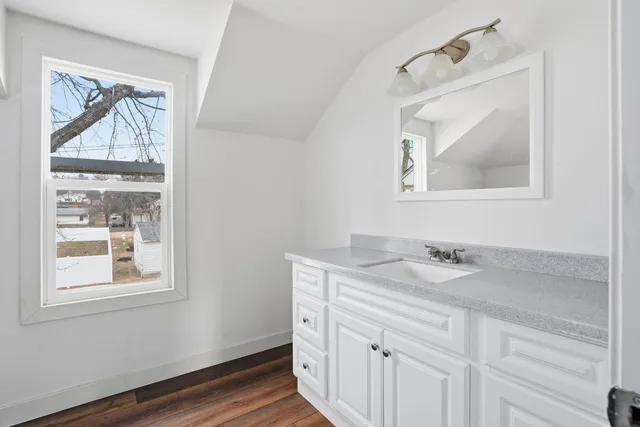 a bathroom with a sink a vanity and a window