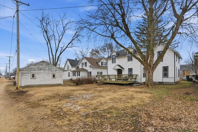 a view of a house with a large tree in front of a house