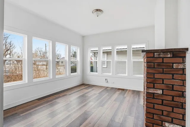 a view of wooden floor and windows in a room