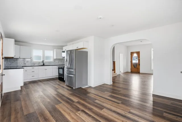 a view of a kitchen with a sink and a refrigerator