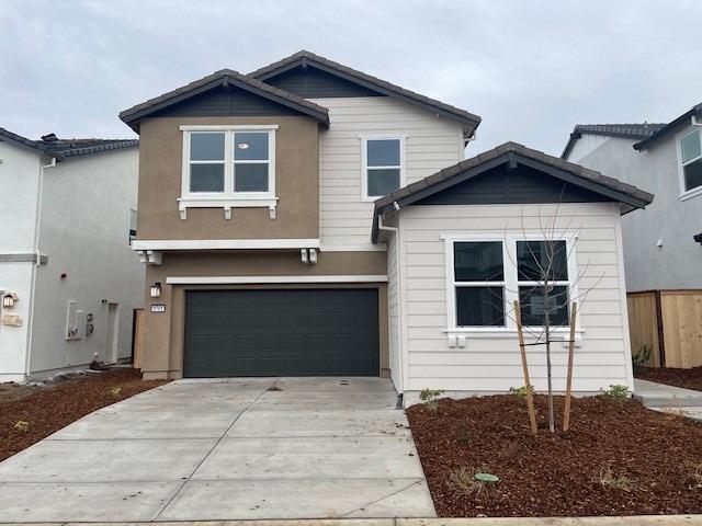 8761 Spring Fern Way Elk Grove, CA 95624 - Photo 1 of 1 a front view of a house with garden