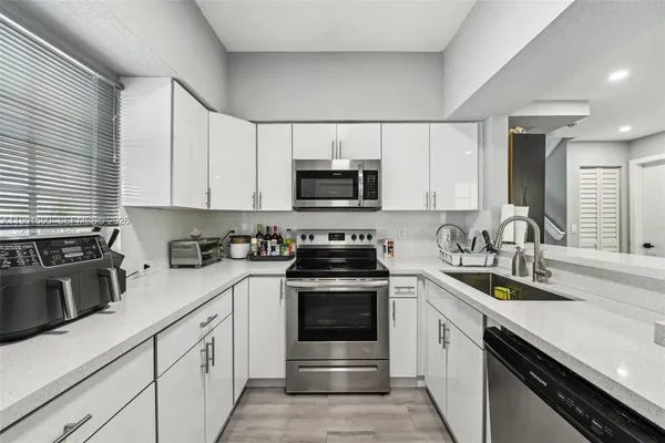 a kitchen with a sink stove and microwave