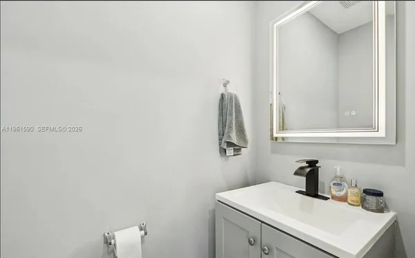 a bathroom with a sink and a mirror