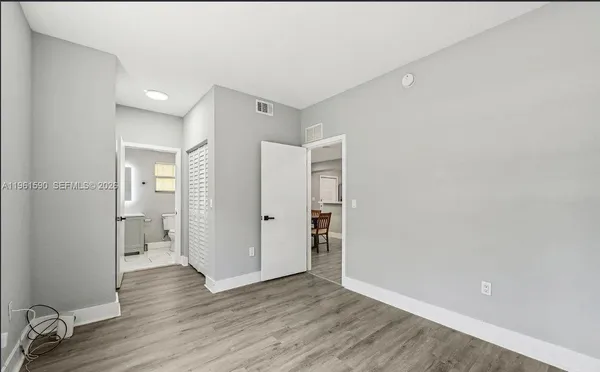 a view of wooden floor and a bathroom