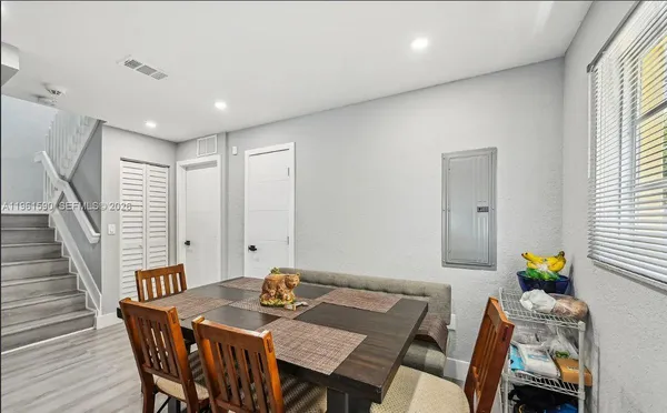a view of a dining room with furniture and wooden floor