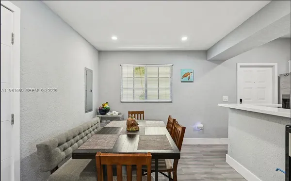 a view of a dining room with furniture and window