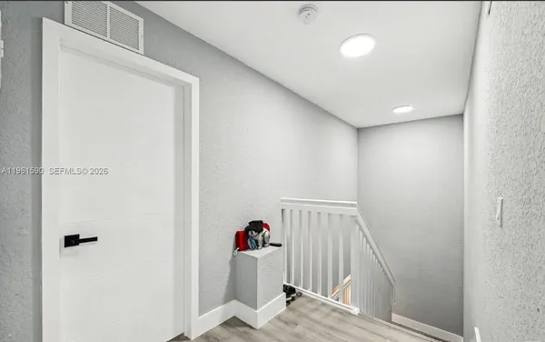 a view of a hallway to a bedroom