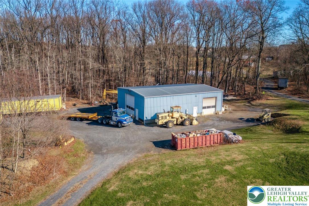 102 East Moorestown Road Wind Gap, PA 18091 - Photo 2 of 9 a backyard of a house with table and chairs