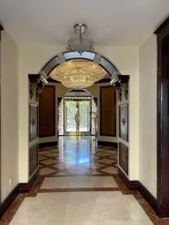 a view of a patio with table and chairs potted plants and a floor to ceiling window