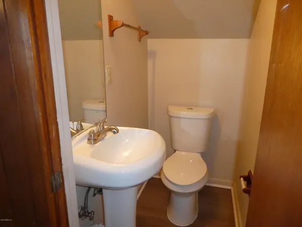 a bathroom with a sink a toilet and a mirror