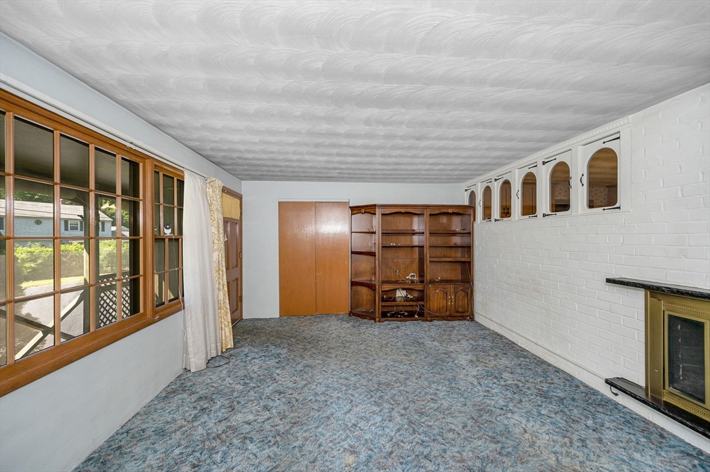 13 Judith Road Chelmsford, MA 01824 - Photo 11 of 36 a view of empty room with floor to ceiling window and fireplace