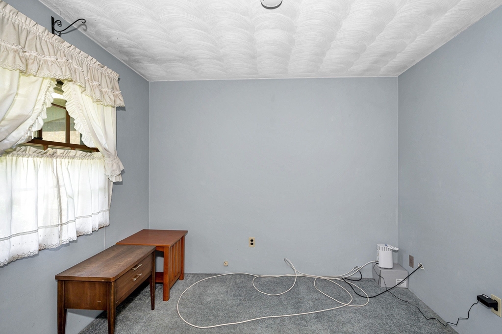 13 Judith Road Chelmsford, MA 01824 - Photo 17 of 36 a room with a window and a couch