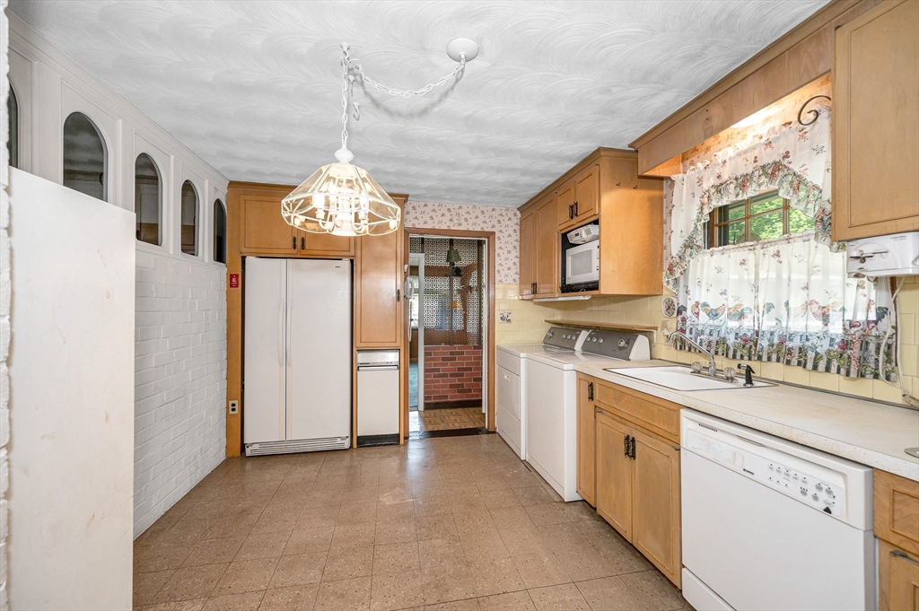 13 Judith Road Chelmsford, MA 01824 - Photo 5 of 36 a large kitchen with stainless steel appliances granite countertop a stove and a refrigerator